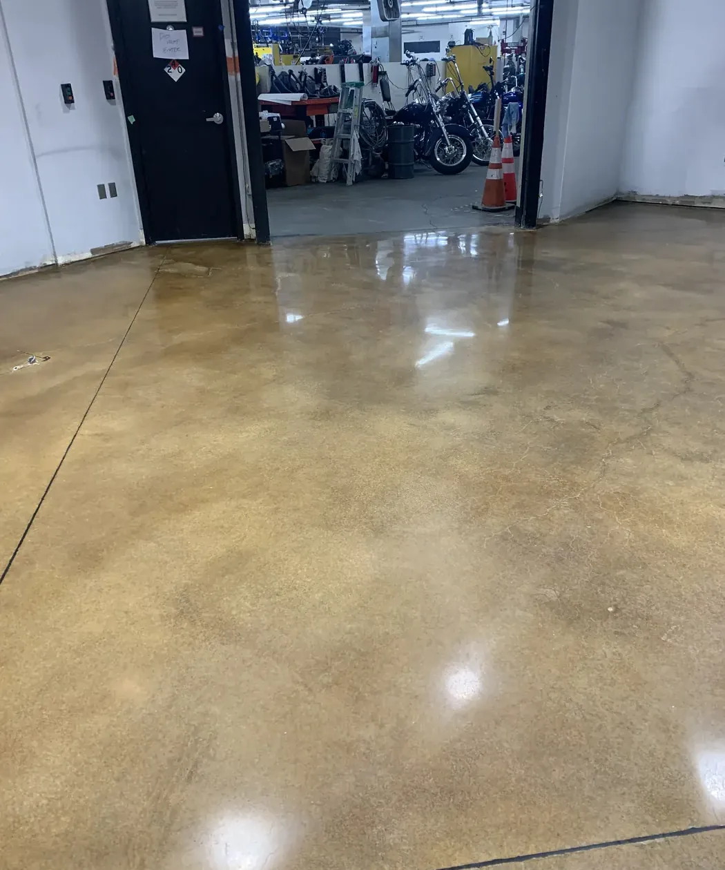 Amber stained and polished concrete floor at a shop doorway