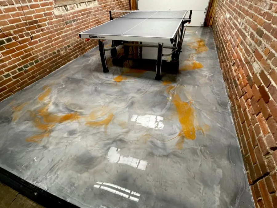 Custom metallic epoxy floor with hand-worked veining